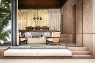A modern living room with a sofa, armchairs, and a coffee table. There is a dining area with chairs and a table. The room has large windows and a view of greenery outside.