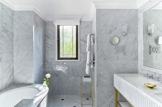 A modern bathroom with a bathtub, a shower, and a vanity with a mirror.